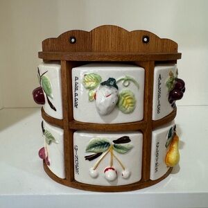 Antique spice rack with fruit designs.